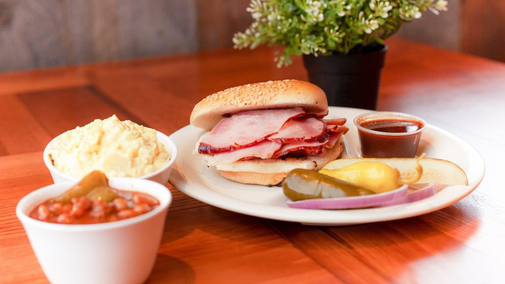 Ham Sandwich Plate · Slices of hickory-smoked ham served on a toasted sesame seed bun with your choice of two home-style sides..