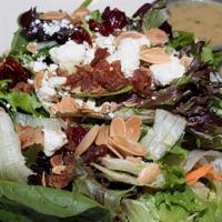 Large Harvest Salad · Mixed greens, chopped apples, dried cranberries, bacon, toasted almonds, and feta cheese. Se...