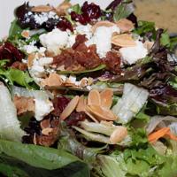 Small Harvest Salad · Mixed greens, chopped apples, dried cranberries, bacon, toasted almonds, and feta cheese. Se...