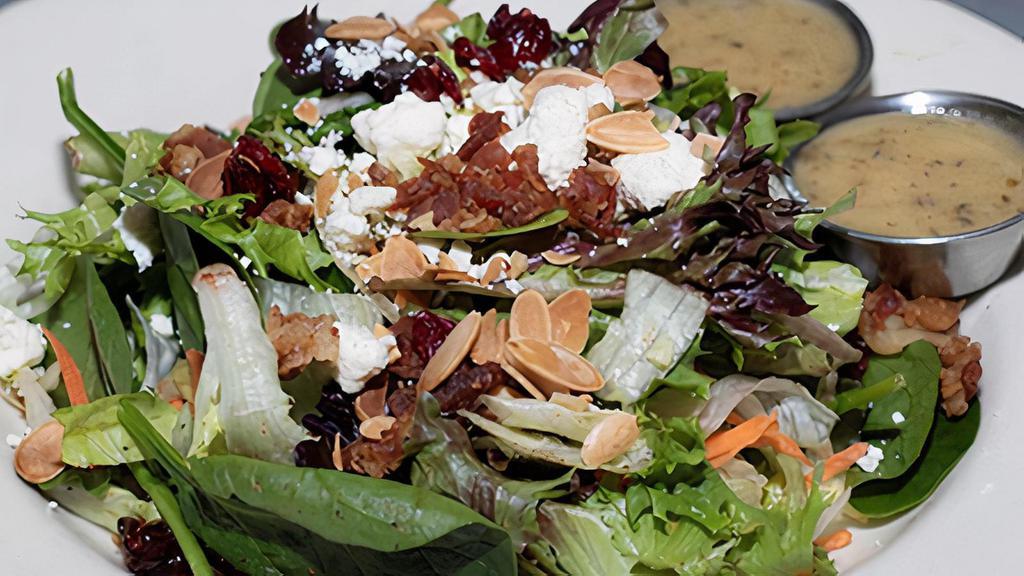 Small Harvest Salad · Mixed greens, chopped apples, dried cranberries, bacon, toasted almonds, and feta cheese. Served with our housemade herb vinaigrette.