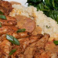 Shrimp 'N Grits · Large blackened shrimp on a bed of jalapeño cheese grits with smoked Andouille sausage gravy...