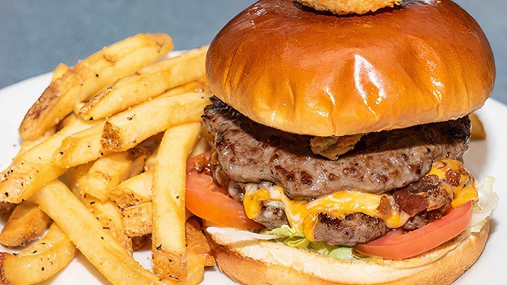 Bacon Double Cheeseburger · Two beef patties seasoned with our signature Rockfish spice and topped with cheddar jack cheese, bacon, fried pickles, shredded lettuce, and tomatoes. Served with crispy fries.