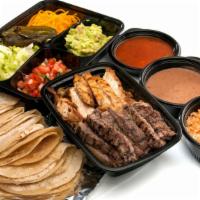 Fajitas For 2 · Served with fresh hand-rolled tortillas and sides of grilled onions, jalapeños, shredded che...