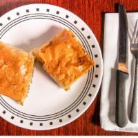 Spinach Pie (Spanakopita) · Flaky phyllo dough stuffed with a mixture of spinach and feta cheese with Greek salad.