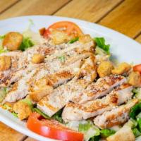 Chicken Caesar Salad · Romaine lettuce, tomato, croutons, cheese and breaded or grilled chicken with Caesar dressing.