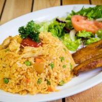 Arroz Con Pollo · Chicken rice mixed with green peas and carrots.