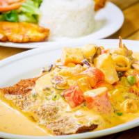 Chuleta A La Calima · Breaded pork sirloin topped with a coconut sauce mixed with seafood and served with rice, gr...
