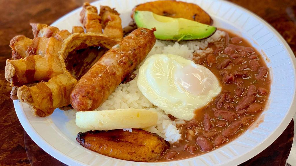 Bandeja Paisa (Small) · Typical Colombian plate served with beef steak, rice, beans, fried sweet plantains, deeply fried pork rind, one fried egg, corn patty, chorizo and avocado.