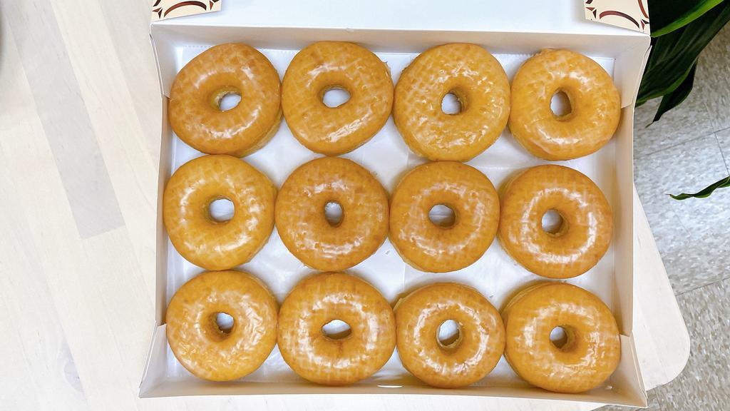 6 Glazed Donut · A box filled with glazed donuts.