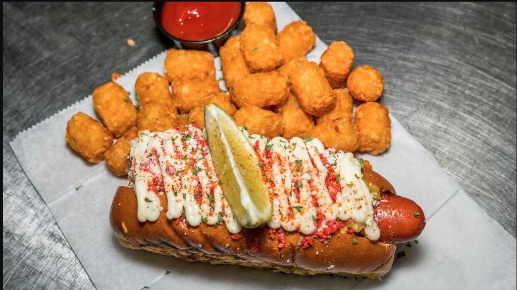 Elote · Texas All Beef Frank, Roasted Corn, Cotija cheese, Crushed Takis (Chips), Parmesan, Mayo Drizzle, Chile, Limon