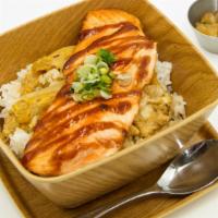 Salmon Teriyaki Don · Grilled salmon over a bowl of rice with onion, egg, donburi sauce and teriyaki sauce.