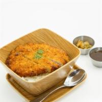 Katsu Don · Japanese pork cutlet over a bowl of rice with onion, egg and donburi sauce.