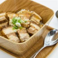 Kakuni Don · Braised pork belly over a bowl of rice with onion, egg and donburi sauce.