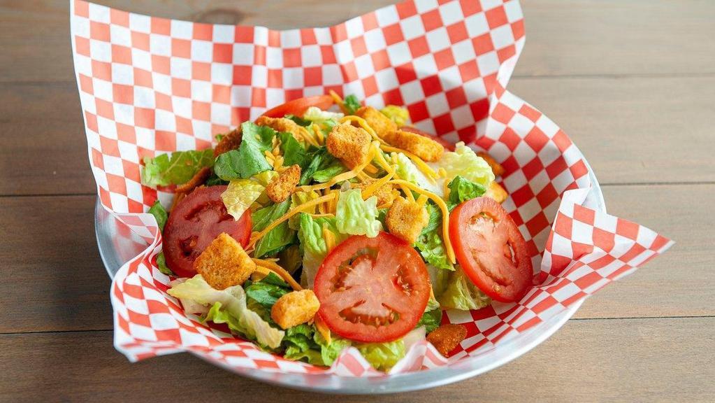 House Salad · A mix of greens, tomato, cheese, and croutons.