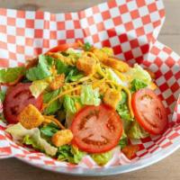 Side Salad · A mix of greens, tomato, cheese, and croutons.