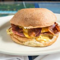 The Grand Croissant Sandwich · Comes with two  scrambled eggs, sausage, crispy bacon, ham, mayonnaise and american cheese