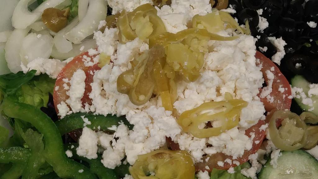 Greek Salad · Tomatoes, cucumbers, onions, olives, and feta cheese in an olive oil dressing.