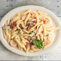Penne Rustica · Penne pasta with grilled chicken, shrimp, mushrooms & sun-dried tomato in a creamy roasted g...