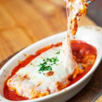 Traditional Lasagna · Stacked fresh pasta sheets, bolognese sauce, parmesan and ricotta cheese.