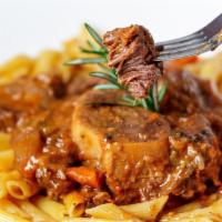 Veal Or Lamb Osso Buco · Slow cooked lamb or veal shank, mirepoix, herbs, red wine over a bed of penne pasta.