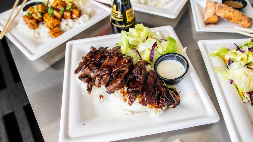 Beef Teriyaki · Over a half pound of marinated skirt steak, grilled to perfection. Covered in fresh teriyaki sauce and served over a bed of rice with a simple side salad.