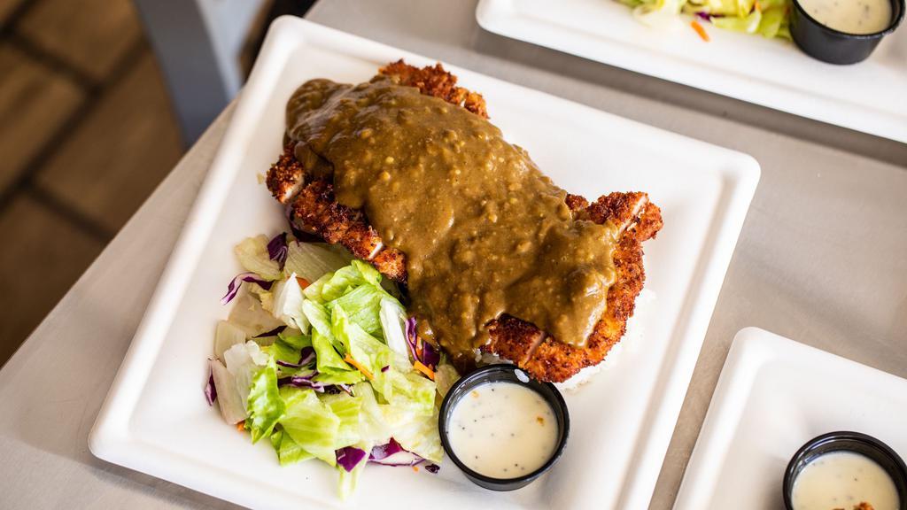 Chicken Katsu Curry · Chicken Katsu Curry is an absolute favorite. Panko breadcrumb coated chicken served with a traditional Japanese Curry sauce over the top. The meal comes with Calrose rice and a side salad.