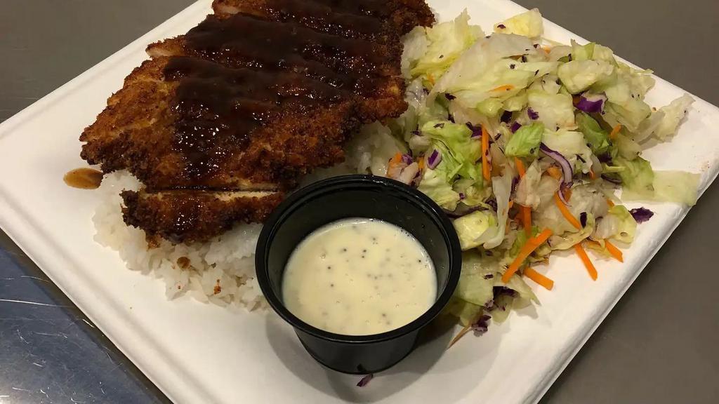 Chicken Katsu · Chicken Katsu is an absolute favorite. Panko breadcrumb coated chicken served with a traditional katsu sauce over the top. The meal comes with calrose rice and a side salad.