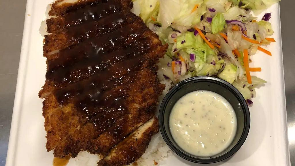 Pork Katsu · Pork Katsu is an absolute favorite. Panko breadcrumb coated tender pork served with a traditional katsu sauce over the top. The meal comes with calrose rice and a side salad.