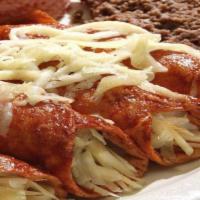 Red Enchiladas Family Pack · 16 Red enchiladas with cheese, 1 Lt. rice, 1 Lt. beans, sour cream 8oz, cheese, 1sauce, 1 so...