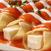 Entomatadas · 4 rolled panela cheese tacos covered w/tomato sauce & sour cream, served w/rice & beans.