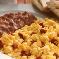 Chorizo Eggs · 2 Scrambled eggs, chorizo, refried beans, red or green chilaquiles.