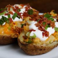 Stuffed Baked Potatoes · Medium baked russet potato, served with real butter, sour cream, mild cheddar cheese, and yo...