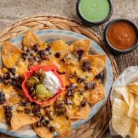 Fajita Nachos · Corn tortilla chips. topped with your choice of fajita, refried beans, and melted jack and c...