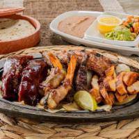 Ivan'S Special · 4-oz of fajita combo, 2 shrimp brochette, 2 bbq ribs, and 2 pieces of sausage served with gu...