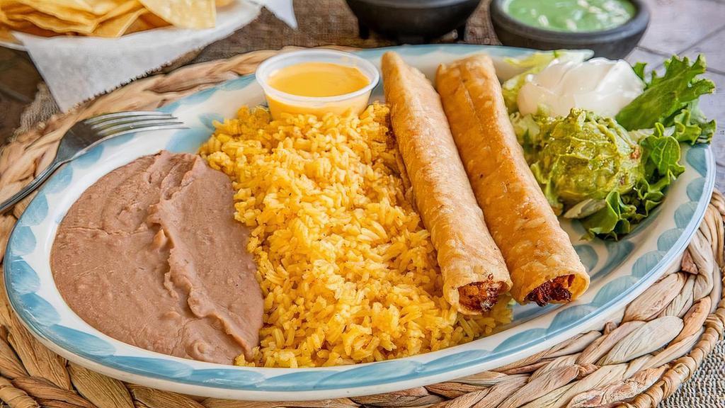 Flautas · Two tortillas filled with shredded chicken and Monterrey jack cheese then rolled and deep-fried.  Served with guacamole, sour cream, queso, and your choice of beans & rice. (Refried beans and Mexican rice Default)