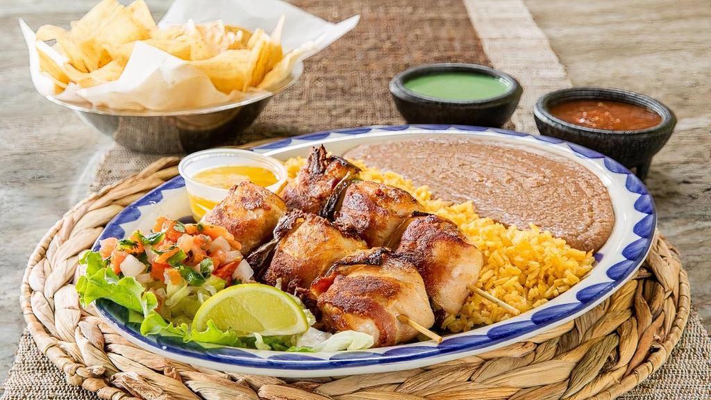Chicken Diablos · Chicken stuffed with jalapeño, cheese and wrapped in bacon.  Served with pico, garlic butter, and your choice of beans & rice. (Refried beans and Mexican rice Default)