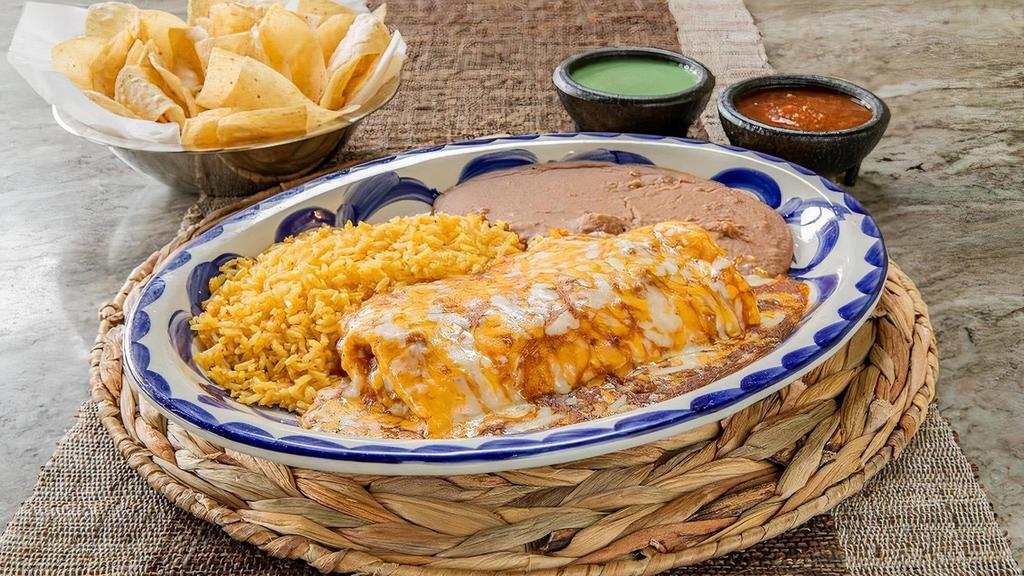 Burrito Dinner · A flour tortilla filled with seasoned ground beef and refried beans, topped with chili gravy and melted cheeses. Served your choice of beans and rice.