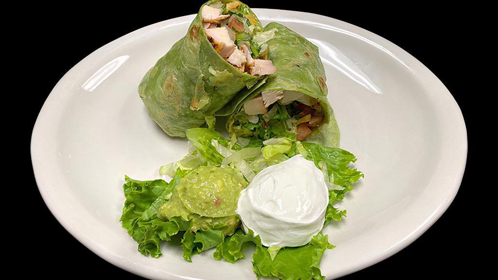 Amazon Wrap · A spinach tortilla stuffed with your choice of fajita meat, tortilla strips, lettuce, tomatoes, pico, and amazon sauce. Served with a side of guacamole, and sour cream.