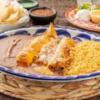 Tia-Juana Dinner · Beef fajita taco, tamale, cheese enchilada & beef enchilada topped with chili con carne and ...