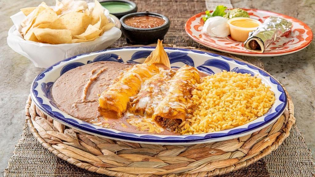 Tia-Juana Dinner · Beef fajita taco, tamale, cheese enchilada & beef enchilada topped with chili con carne and grated cheese, served with a scoop of guacamole and your choice of beans & rice. (Refried beans and Mexican rice Default)