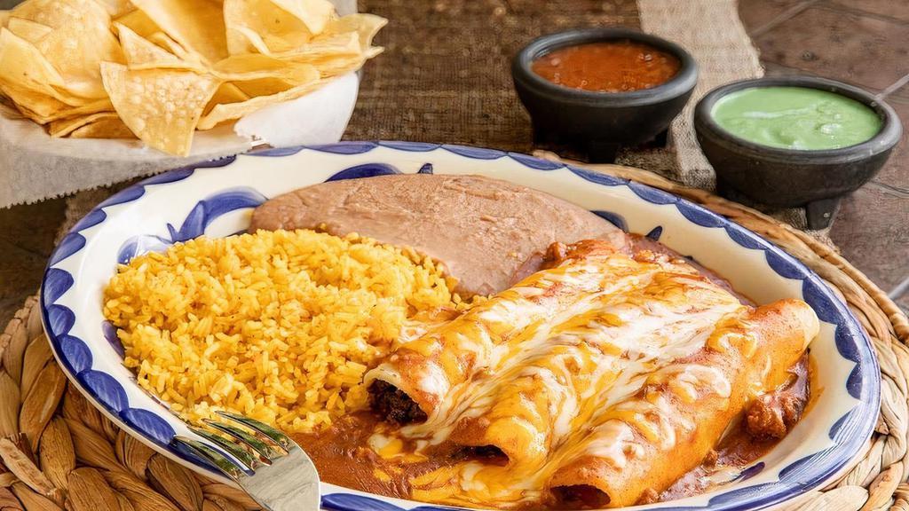 Ground Beef Enchilada Dinner · Enchiladas rolled with seasoned ground beef topped and topped with chili gravy and grated cheese.  Served with your choice of beans & rice. (Refried beans and Mexican rice Default)