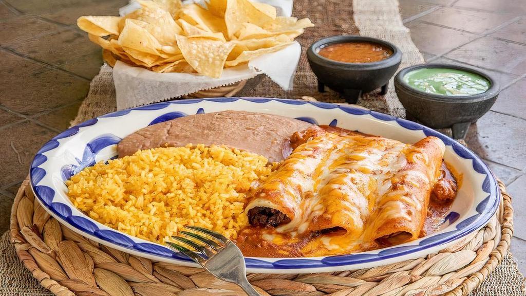 Fajita Enchilada Dinner · Fajita enchiladas topped with chili con carne and grated cheese.  Served with your choice of beans & rice. (Refried beans and Mexican rice Default)