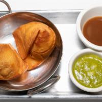Samosa (Vg/Ve) · Vegetarian and Vegan.  Two flaky pastry puffs stuffed with seasoned potatoes & peas served w...