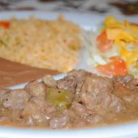 Carne Guisada Plate · Beef tips, rice and beans, salad and two tortillas.