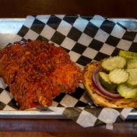 Buffalo Chicken Fried Sandwich · Fried chicken tossed in buffalo sauce, Onions, Pickles on a brioche bun served with a side o...