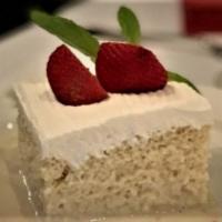 Tres Leches Cake · Sponge cake soaked in 3 types of milk with a vanilla whipped cream icing.