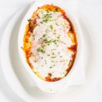 Eggplant Parmigiana · Fresh eggplant breaded and topped with Parmesan and mozzarella cheese, in light tomato sauce...