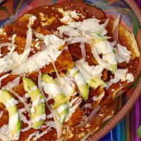 Chilaquiles Rojos · Pieces of corn fried tortillas;  sautéed with  red salsa, and topped with cheese, sour  crea...