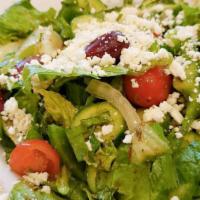 Greek Salad · Lettuce tomatoes green peppers onions feta cheese black olives cucumbers and dressing.