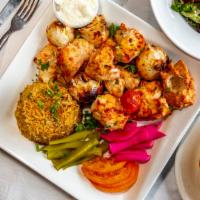 Chicken Kabab · Two skewers served with garlic sauce.